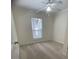 This bedroom features a ceiling fan, neutral carpet, and a window providing natural light at 1833 Phillips Ave, East Point, GA 30344