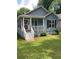 Cozy blue house with a well-manicured lawn, front porch, and classic design elements at 1833 Phillips Ave, East Point, GA 30344