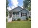 Charming blue house featuring a cozy front porch and well-maintained lawn at 1833 Phillips Ave, East Point, GA 30344
