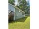 Exterior view of house with blue siding, lawn, and back deck at 1833 Phillips Ave, East Point, GA 30344