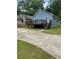 Home exterior with blue siding, back deck, lawn, and a concrete driveway at 1833 Phillips Ave, East Point, GA 30344