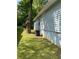 View of the side of the house with light-blue siding, lawn, and an external AC unit at 1833 Phillips Ave, East Point, GA 30344