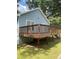 View of the exterior of the home with a backyard deck and green grass at 1833 Phillips Ave, East Point, GA 30344