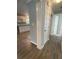 Hallway leading to the kitchen, featuring wood-look floors and neutral paint at 1833 Phillips Ave, East Point, GA 30344