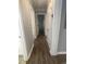 Hallway with wood-look floors and neutral paint provides access to other rooms in the home at 1833 Phillips Ave, East Point, GA 30344