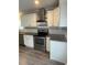 Well-lit kitchen with white cabinets, stainless steel appliances, and granite countertops at 1833 Phillips Ave, East Point, GA 30344