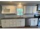 Well-lit kitchen featuring white cabinets, granite countertops, and stainless steel appliances at 1833 Phillips Ave, East Point, GA 30344