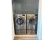 A well-lit laundry room features a front-load washer and dryer at 1833 Phillips Ave, East Point, GA 30344