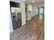 Spacious living room with wood-look floors and stainless steel refrigerator at 1833 Phillips Ave, East Point, GA 30344