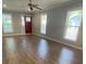 Spacious living room features wood floors and multiple windows, enhancing the natural light at 1833 Phillips Ave, East Point, GA 30344