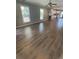 Bright living room featuring wood flooring, white trim, and natural light through large windows at 1833 Phillips Ave, East Point, GA 30344