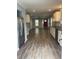 Open-concept space features wood-look floors and a view of the kitchen at 1833 Phillips Ave, East Point, GA 30344