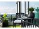 Relaxing outdoor space featuring a small table with cushioned seating, plants, and expansive city views at 700 Park Regency Ne Pl # 1605, Atlanta, GA 30326