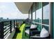 Stunning condo balcony with green turf, black metal chairs, and beautiful views of the city at 700 Park Regency Ne Pl # 1605, Atlanta, GA 30326