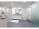 Modern bathroom with a glass-enclosed shower, soaking tub, and dual vanities at 700 Park Regency Ne Pl # 1605, Atlanta, GA 30326