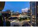 Night-time view of the city from the balcony, featuring nearby buildings at 700 Park Regency Ne Pl # 1605, Atlanta, GA 30326