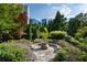 Landscaped common area featuring stone benches and lush greenery, offering a serene outdoor escape at 700 Park Regency Ne Pl # 1605, Atlanta, GA 30326