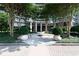 Elegant building entrance with manicured landscaping, trees, and stone walkway at 700 Park Regency Ne Pl # 1605, Atlanta, GA 30326