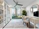 Bright office with built-in shelves, desk, ceiling fan, and sliding doors to the outdoor turf area at 700 Park Regency Ne Pl # 1605, Atlanta, GA 30326