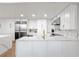 Bright kitchen with custom white cabinetry, stainless steel appliances and beautiful marble countertops at 700 Park Regency Ne Pl # 1605, Atlanta, GA 30326