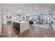 Open-concept living space featuring hardwood floors, modern kitchen, dining area, and sitting area at 700 Park Regency Ne Pl # 1605, Atlanta, GA 30326
