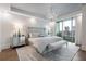 Serene main bedroom with a chandelier, balcony access, and neutral decor at 700 Park Regency Ne Pl # 1605, Atlanta, GA 30326