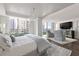Bright main bedroom with hardwood floors, a crystal chandelier, and a sitting area with city views at 700 Park Regency Ne Pl # 1605, Atlanta, GA 30326