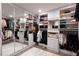 Large walk-in closet with custom shelving, mirrored doors, and ample storage space at 700 Park Regency Ne Pl # 1605, Atlanta, GA 30326