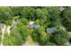 An aerial view showing the property, lush trees, swimming pool, and neighboring houses at 865 Old Creek Trl, Atlanta, GA 30328