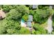 An aerial view of a house showcasing the backyard pool and lush greenery surrounding the property at 865 Old Creek Trl, Atlanta, GA 30328