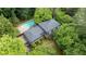 Aerial view displaying the pool and manicured lawn, nestled within a lush, tree-filled landscape at 865 Old Creek Trl, Atlanta, GA 30328