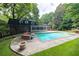 A large backyard pool and patio, complete with a spa and adjacent sunroom, perfect for entertaining at 865 Old Creek Trl, Atlanta, GA 30328