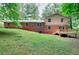 Back of the house features a deck and sprawling lawn, perfect for relaxation and entertainment at 2802 Leisure Woods Ln, Decatur, GA 30034
