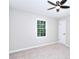 Bedroom with neutral walls and plush carpet, a ceiling fan and a window at 2802 Leisure Woods Ln, Decatur, GA 30034