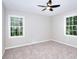 Bedroom with soft carpet and two windows providing ample sunlight at 2802 Leisure Woods Ln, Decatur, GA 30034