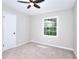 Bright bedroom features a ceiling fan, neutral walls and carpet, and a window at 2802 Leisure Woods Ln, Decatur, GA 30034