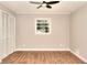 Cozy bedroom with laminate floors, neutral paint, closet, and a window for natural light at 2802 Leisure Woods Ln, Decatur, GA 30034