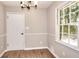 Dining room features laminate floors, chair rail, and updated light fixture, filled with natural light at 2802 Leisure Woods Ln, Decatur, GA 30034