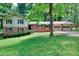 Traditional two-story home with attached garage, featuring a well-manicured front lawn at 2802 Leisure Woods Ln, Decatur, GA 30034