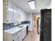 Spacious kitchen with white cabinetry, stainless steel sink, and a view of the staircase at 2802 Leisure Woods Ln, Decatur, GA 30034