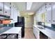 Bright kitchen featuring white cabinets, modern countertops, stainless steel appliances, and backsplash at 2802 Leisure Woods Ln, Decatur, GA 30034