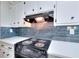 Close up of kitchen features white quartz countertops, stainless steel appliances, and tiled backsplash at 2802 Leisure Woods Ln, Decatur, GA 30034