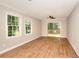 Bright living room with laminate floors, neutral paint, and a sliding glass door to the deck at 2802 Leisure Woods Ln, Decatur, GA 30034