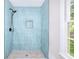 Modern shower with blue vertical tile, penny tile floor, and sleek black fixtures at 2802 Leisure Woods Ln, Decatur, GA 30034
