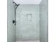 Stylish tiled shower with glass panel and black fixtures at 2802 Leisure Woods Ln, Decatur, GA 30034