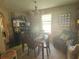 Well-lit dining room with a traditional chandelier, table set for a meal, and a cozy seating area nearby at 413 W Wind Dr, Villa Rica, GA 30180