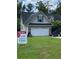 Charming home featuring a two-car garage and a well-maintained front yard at 413 W Wind Dr, Villa Rica, GA 30180