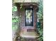 Charming front door with decorative wreath and hanging lantern, adding curb appeal to the home's entrance at 413 W Wind Dr, Villa Rica, GA 30180