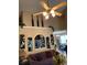 Bright living room with a high ceiling, ceiling fan, and decorative accents above an archway at 413 W Wind Dr, Villa Rica, GA 30180