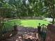Spacious backyard with lush green lawn, brick steps, and beautiful landscaping with mature trees at 881 Park Manor Nw Ct, Marietta, GA 30064